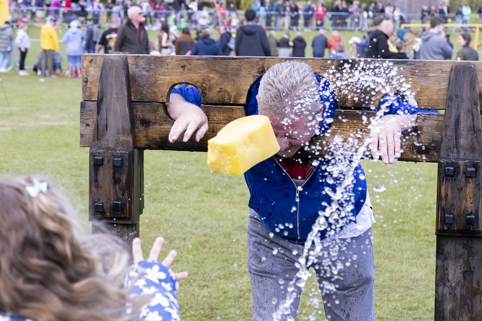 Festival visitors enjoying the stocks at the Dunfermline Bruce Festival
